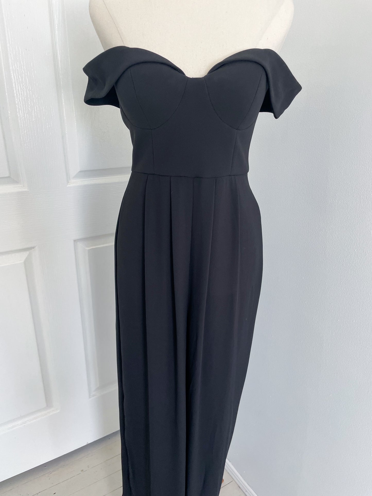 Sheike one piece pant suit or jumpsuit with off the shoulder detail and sheer see through legs. up close