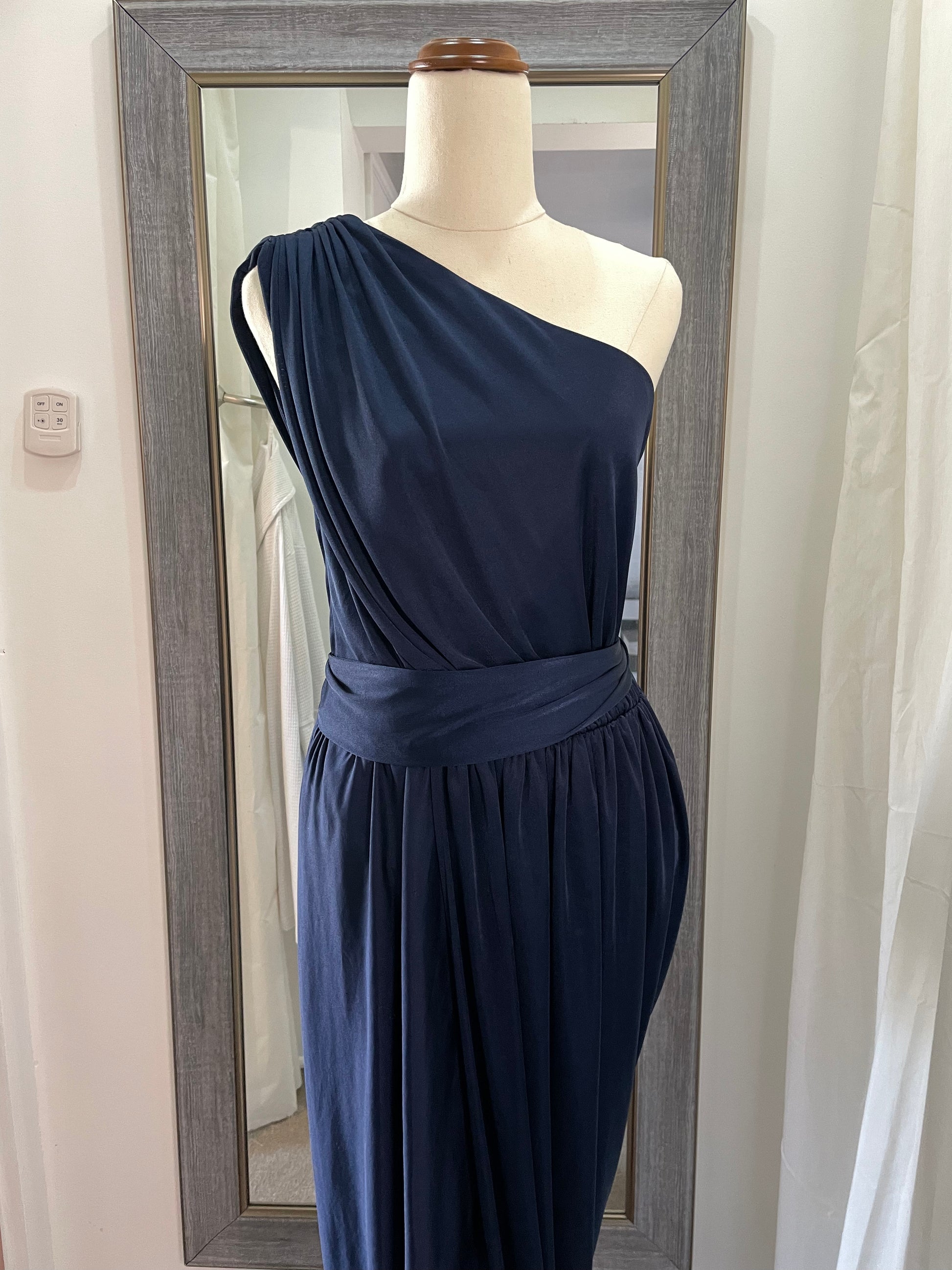 Sheike navy blue cocktail dress. one shoulder, draping material with leg split and waist tie up close