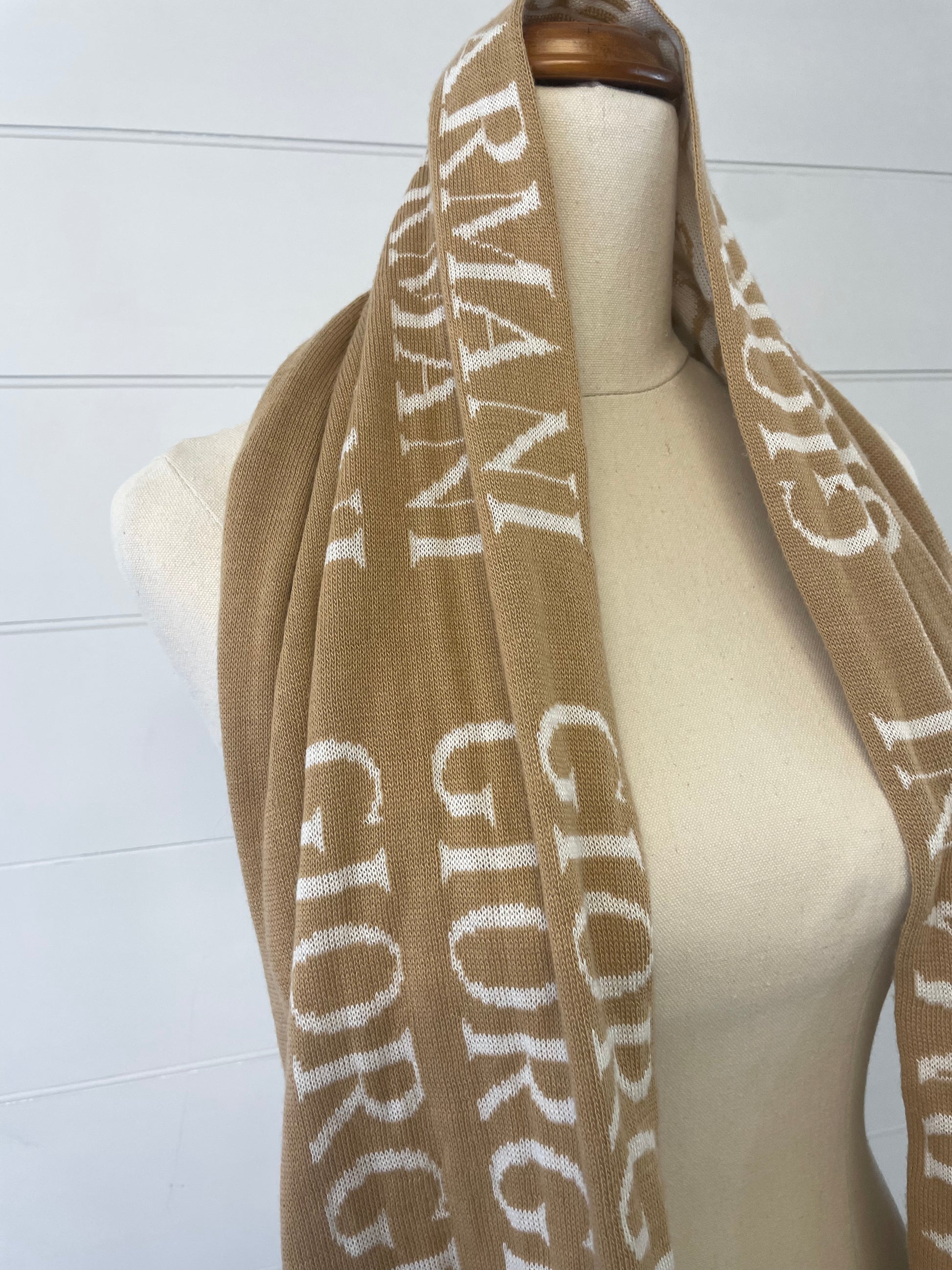 Giorgio Armani 100% wool scarf. Camel colour with white font and orange hem upclose picture