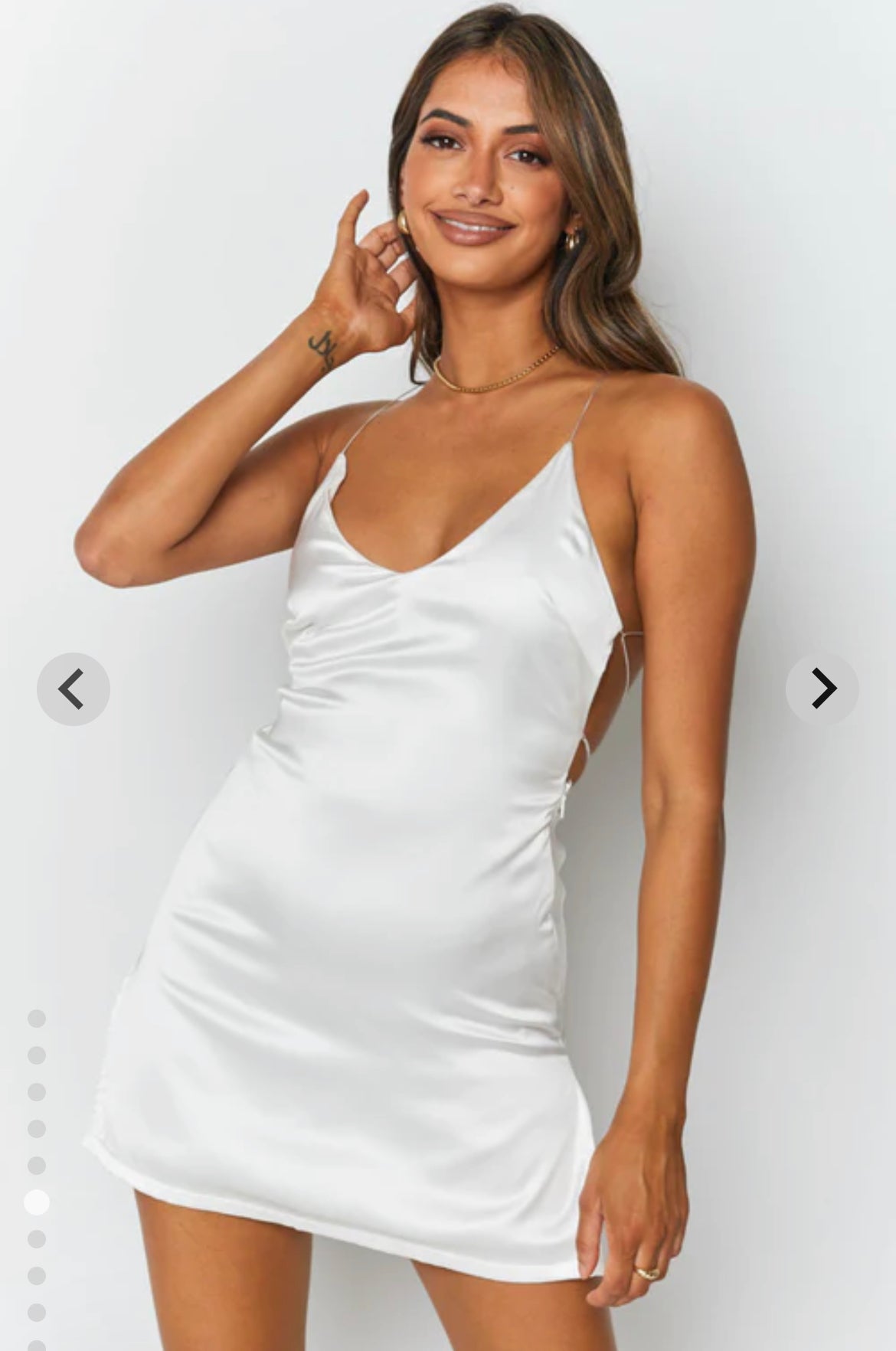 satin white mini dress for clubbing or party with tie up back and v neck . short dress. girl smiling 